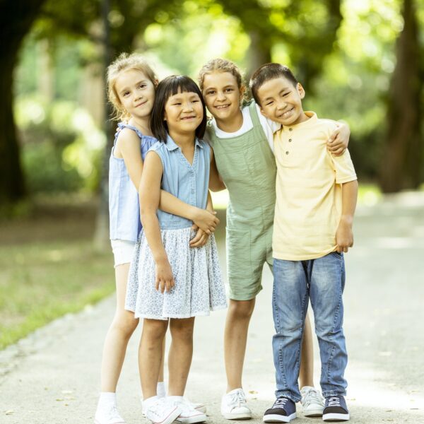 Group of asian and caucasian kids having fun in the park
